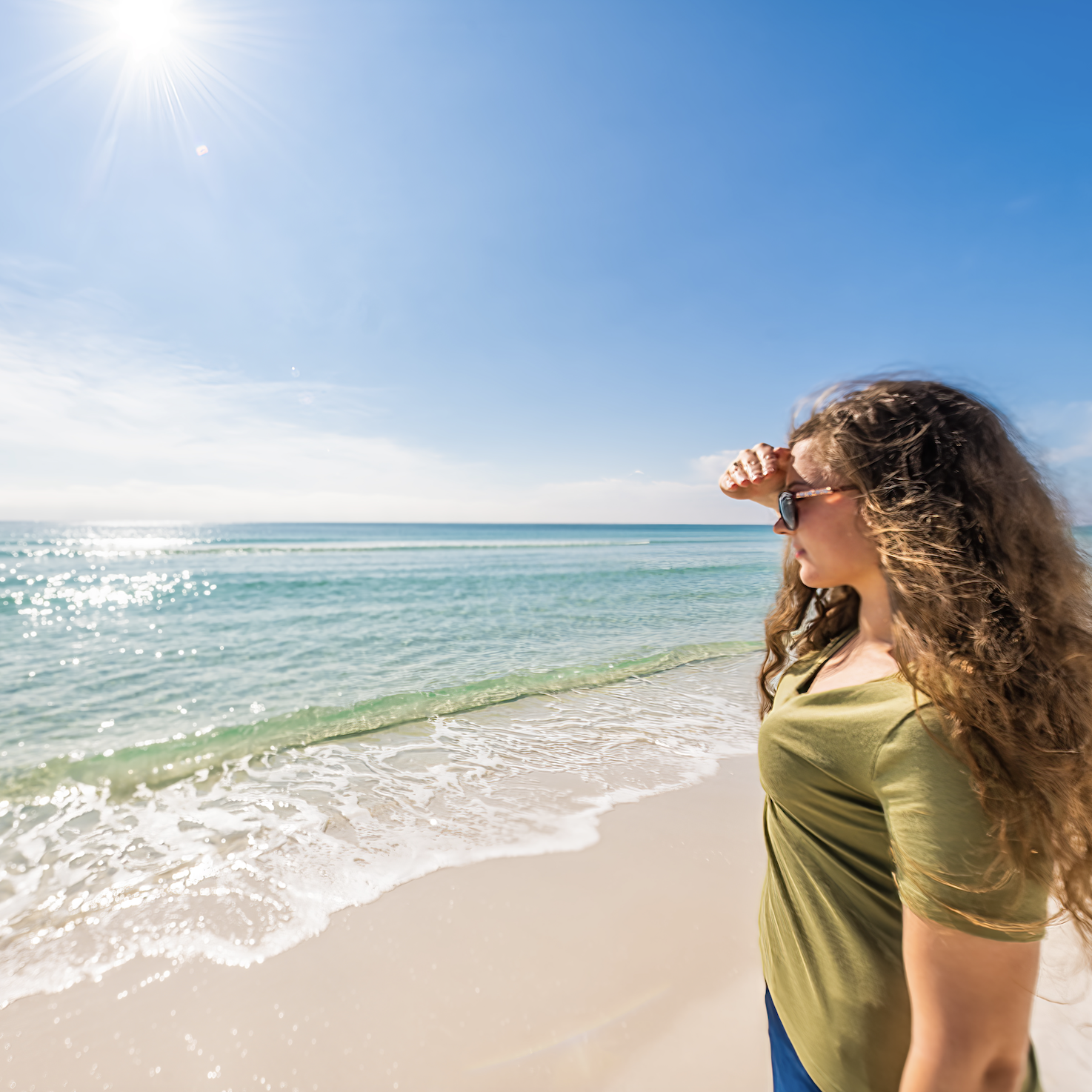 Girl looking out to the ocean water 